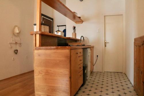 a kitchen with a wooden counter with a sink at Appartment Riva view in Šibenik
