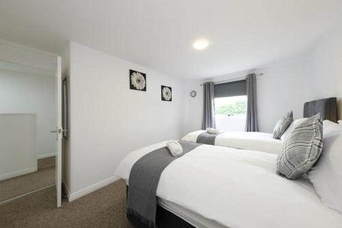 a bedroom with two beds and a window at Premier Apt - Bridge View-Rosyth in Rosyth