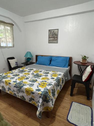 a bedroom with a bed with a floral comforter at Treasure Beach Resort in Carles