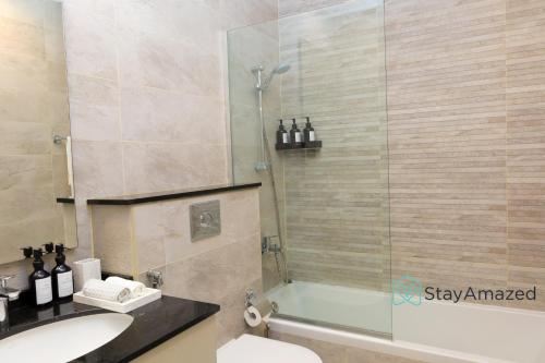 a bathroom with a shower and a toilet and a sink at Amazing 2 BR in The Polo Residence Meydan in Dubai