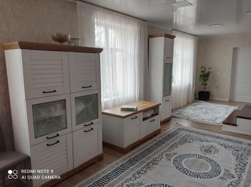 a room with a large white cabinet and a rug at Save Haven Karakol in Karakol