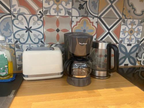 a coffee maker and a toaster sitting on a counter at 2 pièces Cozy in Nice