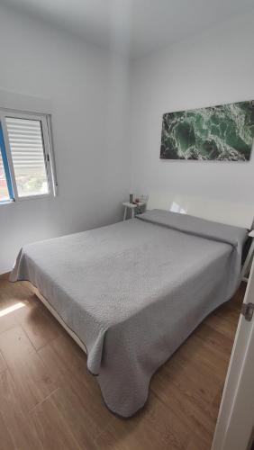 a bedroom with a large bed in a room at LA CASA DEL ALMÁCIGO in Arona