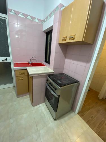 a small kitchen with a stove and a sink at Gzira Centre Apartment in Il-Gżira