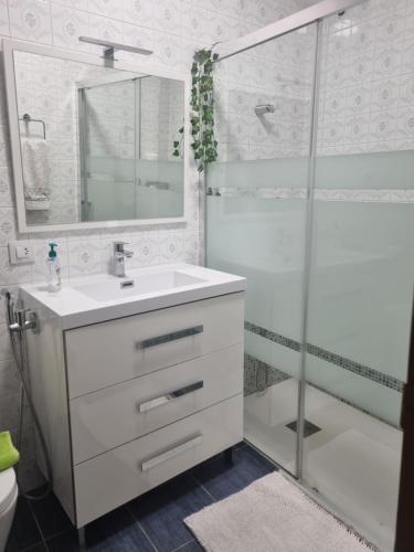 a bathroom with a white sink and a shower at Casa Mara in Zamora