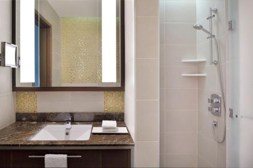 a bathroom with a sink and a shower at Delta Hotels by Marriott City Center Doha in Doha