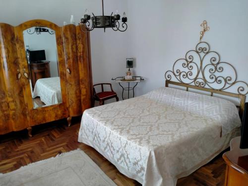 a bedroom with a large bed and a mirror at Ca' Molino Giare 1 in Mira