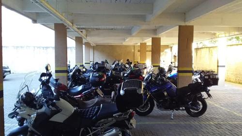 a group of motorcycles parked in a parking garage at Royal Trip Hotel in Guarapuava