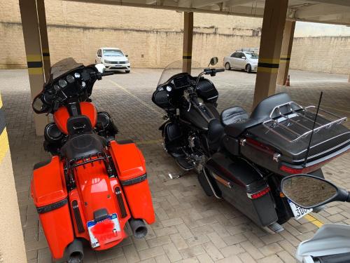 a red motorcycle parked in a parking lot at Royal Trip Hotel in Guarapuava