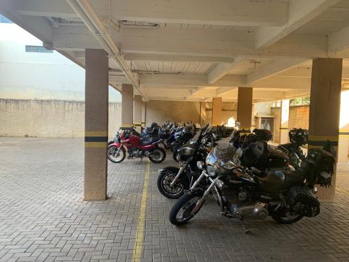 a group of motorcycles parked in a parking lot at Royal Trip Hotel in Guarapuava