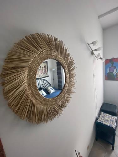 a mirror hanging on a wall with a living room at Casa Bouganville, vista mare! in Lipari