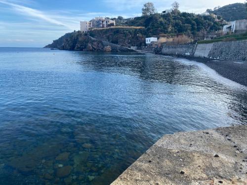 a large body of water with a castle in the background at Casa Bouganville, vista mare! in Lipari