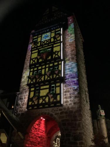 a tower with a stained glass window on it at chez Coco in Riquewihr