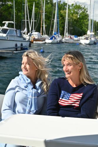 two women sitting on a boat in the water at Sankt Anna Resort in Sankt Anna