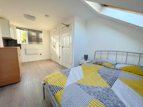 a bedroom with a bed and a dresser and a window at Exeter Road Rooms in South Norwood