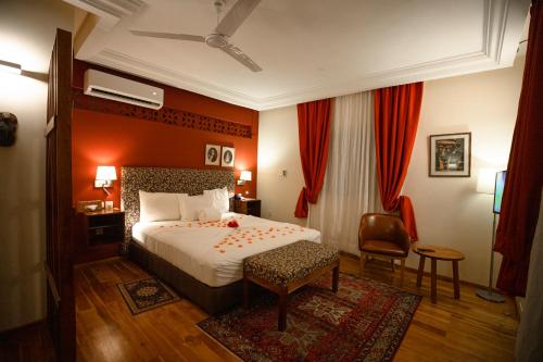 a hotel room with a bed and a chair at Golden Hill Parker Hotel in Elmina