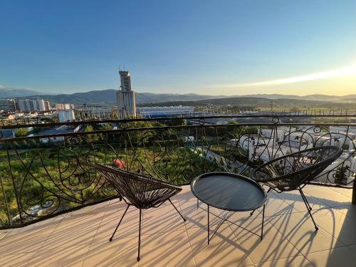 a pair of chairs and a table on a balcony at Modern, City/Industrial Style in Ferizaj