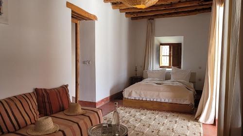 a living room with a bed and a couch at Le Douar Berbere in Ourika