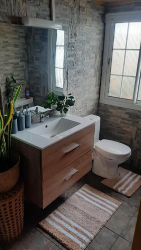 a bathroom with a sink and a toilet at Lepetitcoinenchante in Saint-Louis