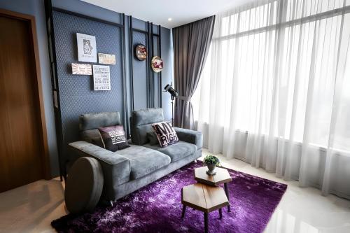 a living room with a couch and a purple rug at Vortex Klcc Penthouse Twins Tower View in Kuala Lumpur