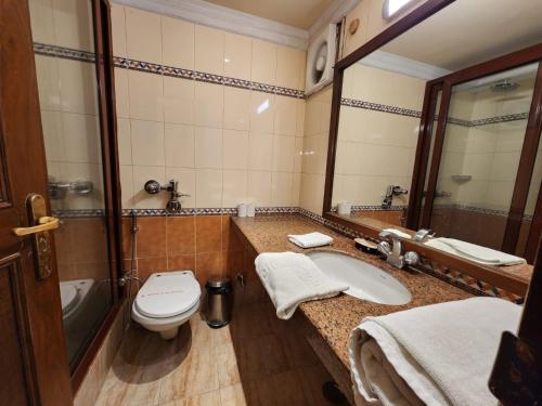a bathroom with a toilet and a sink at Palace On Ganges - Heritage Hotel in Varanasi