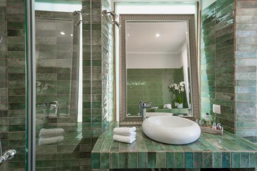 a bathroom with a sink and a bath tub at Paxos Fairytales House 2 in Gaios