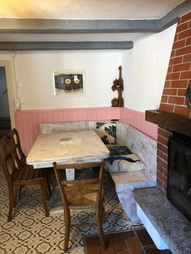 a table and chairs in a room with a fireplace at Casa dell'Arte in Lugano