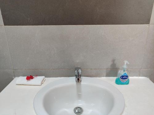 a bathroom sink with a bottle of soap on it at Kisuri Resort in Sena