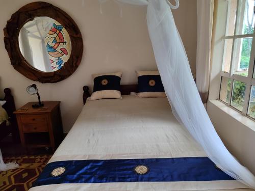 a bedroom with a bed with a mosquito net at Kisuri Resort in Sena