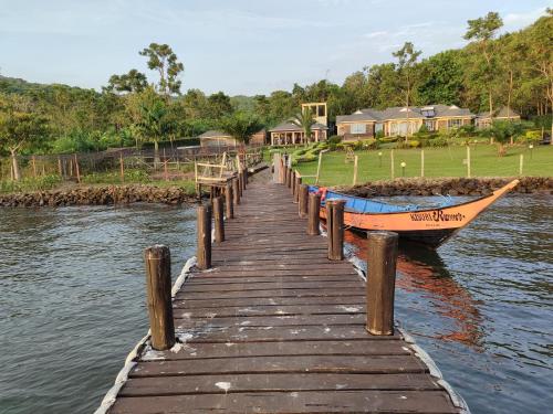 a boat is docked next to a wooden dock at Kisuri Resort in Sena