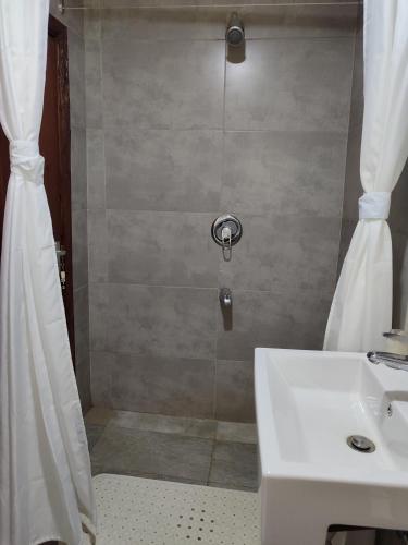 a bathroom with a shower and a sink at Kisuri Resort in Sena
