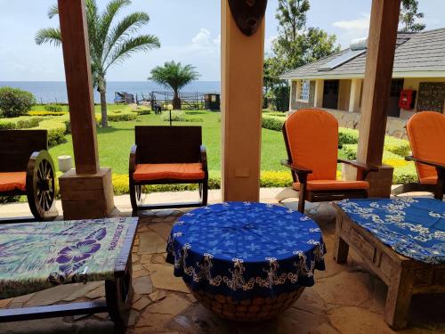 a patio with chairs and a blue table and chairs at Kisuri Resort in Sena
