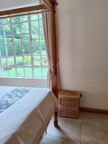 a bedroom with a bed and a large window at Kisuri Resort in Sena