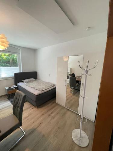 a bedroom with a bed and a mirror and a desk at Großzügige Wohnung in Lüdenscheid