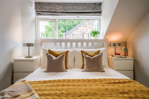 a bedroom with a large bed with a window at The Bribie in Harrogate