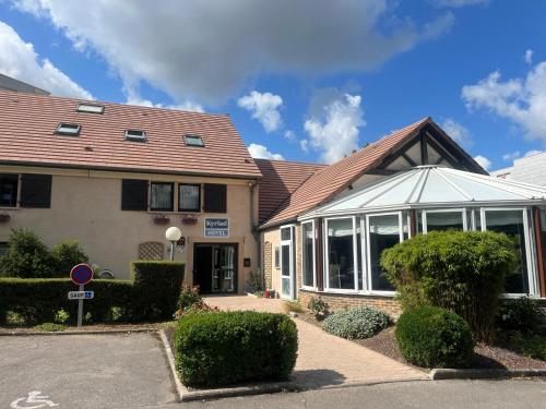 a house with a building with a lot of windows at Kyriad Epernay in &Eacute;pernay
