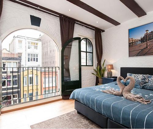a bedroom with a bed with an animal on it at Crown Guesthouse Amsterdam in Amsterdam