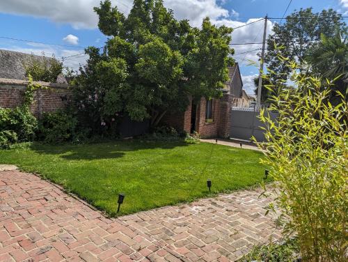 a yard with a brick driveway and a yard with a yard at Chez le Petit Peintre in Laboissière-en-Thelle