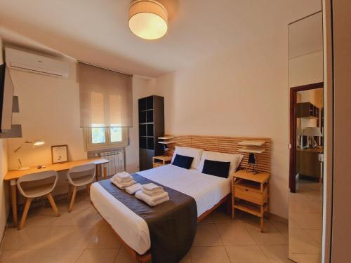 a bedroom with a bed and a desk and a table at Guest House DEA OPI in Rome