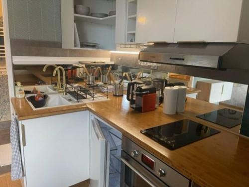 a kitchen with a sink and a counter top at Appartement, place Morny. in Deauville
