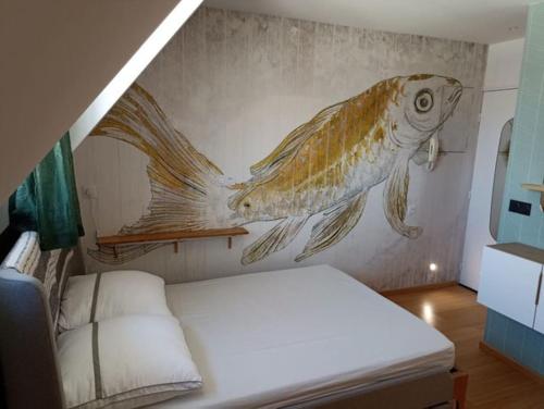 a bedroom with a painting of a fish on the wall at Appartement, place Morny. in Deauville