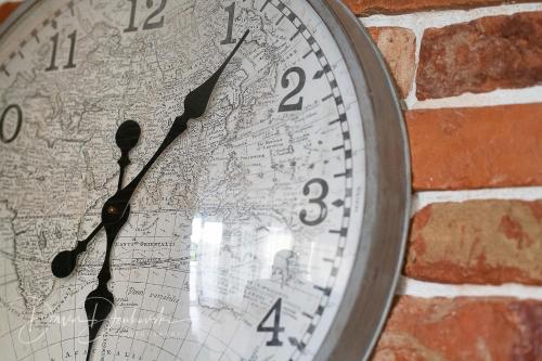a clock is hanging on a brick wall at Island Villa Adriana with heated pool and sauna in Lun