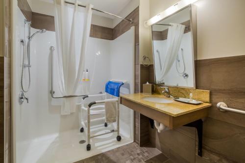 a bathroom with a sink and a shower at Hotel 11, MOD A Sonesta Collection in Calgary