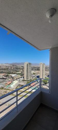 a room with a balcony with a view of a city at ARRIENDO DEPARTAMENTO AVDA .DEL MAR LA SERENA, CHILE in Coquimbo