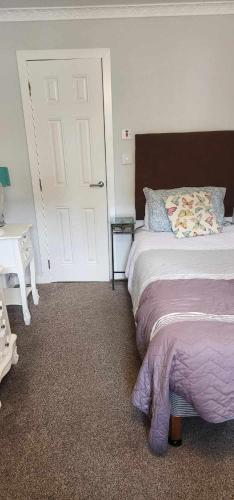 a bedroom with a bed and a white door at No 26 rooms in Inverness