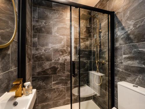 a bathroom with a shower with a glass door at The Stag Pub, Beech Room in Salhouse