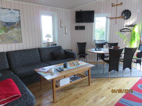 a living room with a couch and a table at Enebackens Kraftkälla in Tvååker