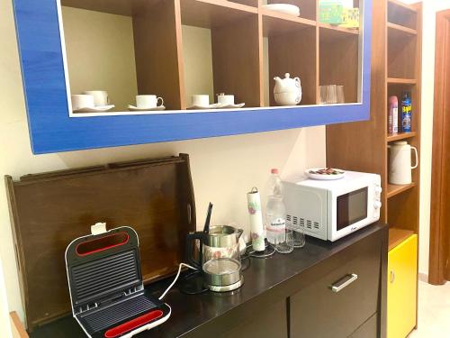 a kitchen counter with a toaster and a microwave at “Stadium” Apartment in Tirana