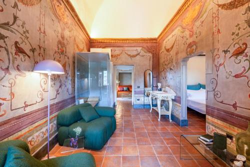 a living room with a couch and a bedroom at Castello di Limatola in Limatola