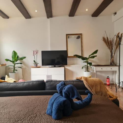 a living room with a couch and a tv at Crown Guesthouse Amsterdam in Amsterdam